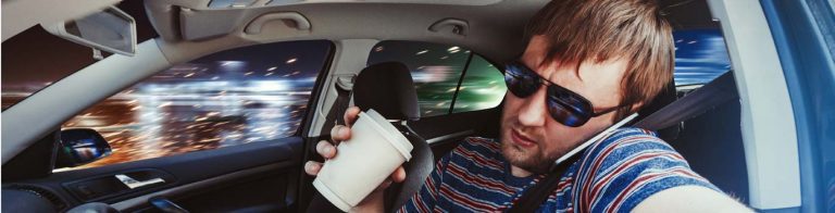 guy drinking coffee, talking on phone distracted driving