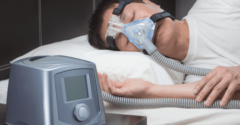 man sleeping with CPAP machine