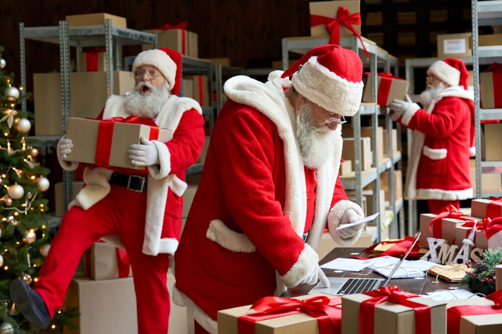 santas working to ship packages for christmas
