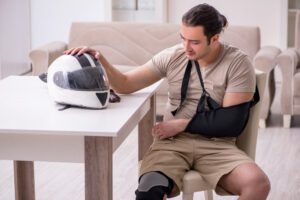 A rider with his arm in a sling. A Providence motorcycle accident lawyer can fight to maximize your compensation.