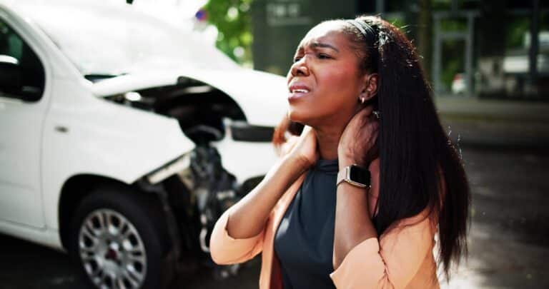 A woman with an injured neck after a car accident, wondering how to claim lost wages.