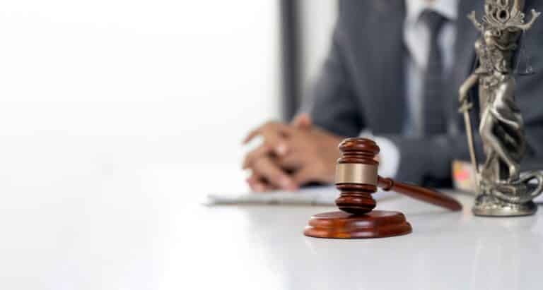A truck accident lawyer sitting at their desk with a gavel in the foreground. What does a truck accident lawyer do?