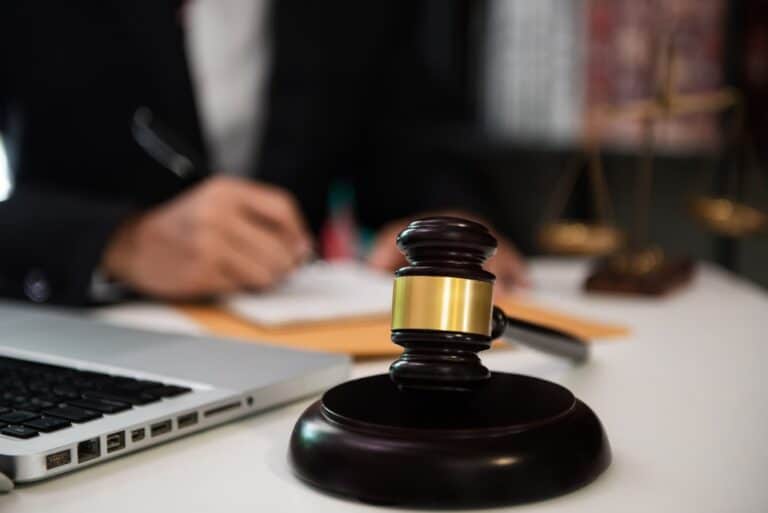 A truck accident lawyer sitting at their desk with a gavel in the foreground. When should I consult a truck accident lawyer?