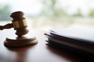 A gavel sitting next to a stack of papers. What are the odds of winning a personal injury lawsuit in Providence?
