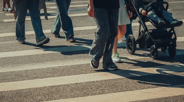 Pedestrians crossing the road. What happens if a pedestrian caused an accident in Rhode Island?