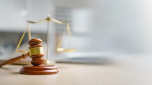 A gavel in front of the scales of justice. Is mediation legally binding in personal injury cases in Rhode Island?