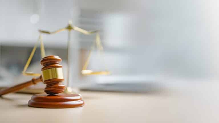 A gavel in front of the scales of justice. Is mediation legally binding in personal injury cases in Rhode Island?