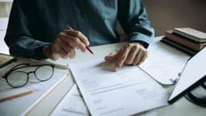 hands reviewing contract documents desk